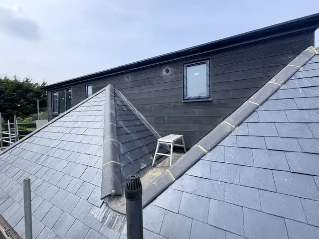 Slate-clad dormer and roof on a completed loft conversion project showing new leadwork and cladding.